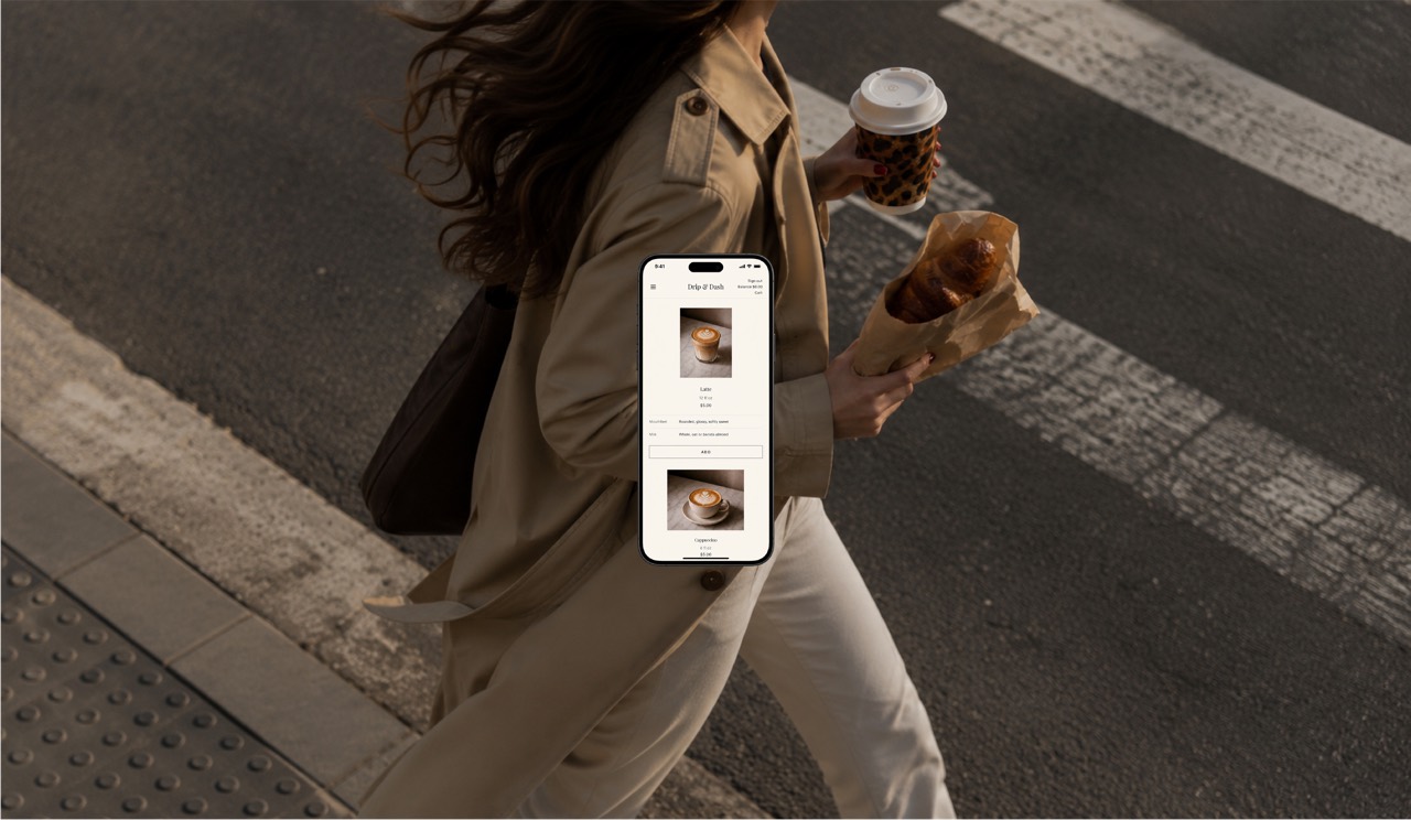 Customer crossing the street with coffee and a pastry while ordering on the Drip & Bake app